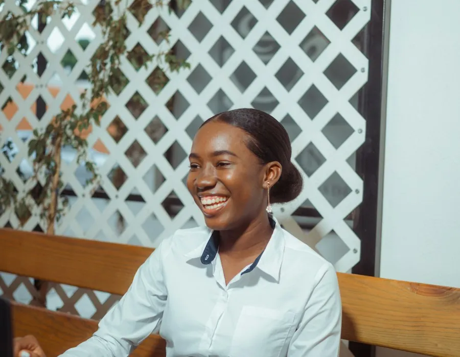 A smiling hotel manager working on a laptop
